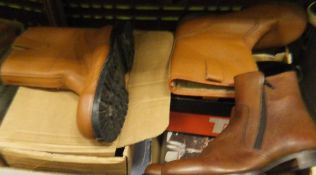 A box containing various shoes including two pairs of Loake ankle boots (one brown,