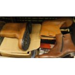 A box containing various shoes including two pairs of Loake ankle boots (one brown,