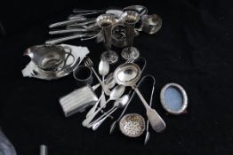 A collection of small silver wares to include a pair of fluted vases, two pairs of sugar tongs,