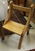 A set of four pine Gothic revival dining chairs with shaped end supports and rectangular seats and