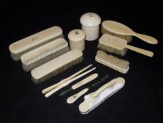 A collection of various carved and turned ivory wares, including two dressing table pots,
