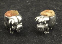 Two silver miniature pin cushions as smiling pigs, one with indistinct hallmark,