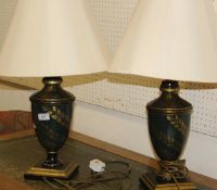 A pair of modern lamps in a dark green ground with gilt leaf decoration,