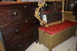 A Victorian stained pine chest of three drawers together with a Lloyd Loom ottoman and a gilt