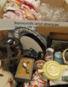 A box of various glass ware and linen and a box containing an oak cased mantle clock,