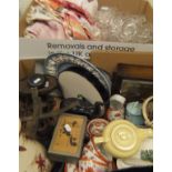 A box of various glass ware and linen and a box containing an oak cased mantle clock,