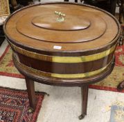 A George III mahogany and brass bound oval wine cooler with twin handles,