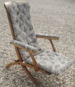 A early to mid 20th Century steamer style chair with floral upholstery