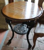 A pair of Victorian cast iron based pub tables with circular mahogany tops