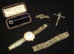 A 9 carat gold gate link bracelet, a 9 carat gold brooch as a bamboo love heart,
