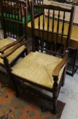 A set of eight (6 + 2) oak framed spindle back dining chairs with rush seats,