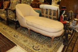 A walnut framed chaise longue with pink ground self patterend upholstery,