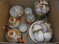 A Japanese eggshell china part tea service decorated with geishas and garden comprising tea cups,