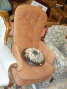 A Victorian button back armchair,