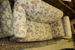 A circa 1900 drop arm Chesterfield sofa with floral upholstery raised on bun feet together with a