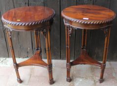 A modern pair of circular occasional tables raised on three multi column supports united by a