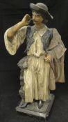 A circa 1900 painted pottery figure of a Spanish gaucho tweaking his moustache,