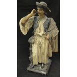 A circa 1900 painted pottery figure of a Spanish gaucho tweaking his moustache,