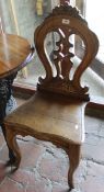 A pair of Victorian oak panel seat hall chairs
