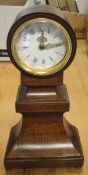 A mahogany cased mantel clock with blue Roman numerals to the enamelled dial,