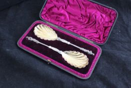 A pair of Victorian silver fruit spoons with gilded shell shaped bowls and Apostle finials (by