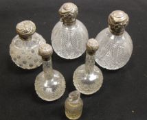 A pair of silver mounted and lidded cut glass grenade scent bottles (by W & G Neal, London 1895),