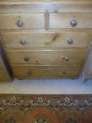 A Victorian pine chest of two short above three long drawers raised on bun feet