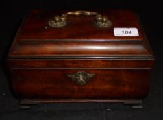 A late George III mahogany tea caddy of bombé sarcophagus form with lacquered brass ornate swan