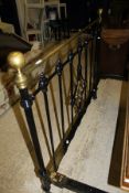 A brass and painted metal double bedstead in the Victorian taste