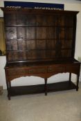 An 18th Century oak dresser with the three tier plate rack above a plain top,