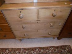 A Victorian pine chest of two short above two long drawers raised on turned bun feet