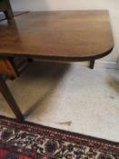A 19th Century oak drop-leaf dining table with rounded corners