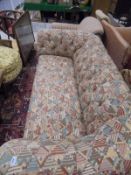 A three seat Chesterfield sofa in abstract button back upholstery,