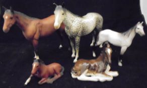 A Beswick matt glazed hunter, a Beswick dapple grey hunter, a Beswick style horse figure,