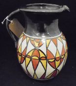 A 20th Century Studio Pottery jug with stylised geometric pattern in ochre and terracotta on cream