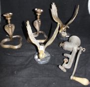 A pair of Indian bronze candlesticks in the form of cobras,