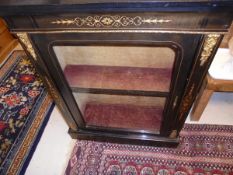 A Victorian ebonised and inlaid display cabinet with ormolu mounts raised on a plinth base with