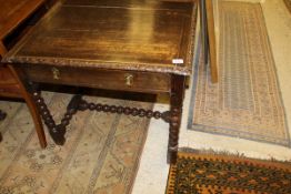 A 19th Century oak single drawer side table, the plain top with carved edge above a single drawer,