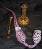 A Nailsea glass pipe with white enamel on a cranberry ground together with a Turkish glass