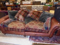 A three seat sofa in brown leather,