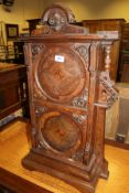 A 19th Century mahogany single door cupboard with carved and moulded pediment above a single door