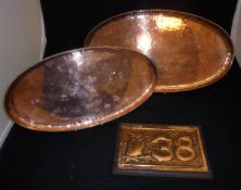 An embossed copper wall plaque decorated with an owl upon a branch and the number "38",