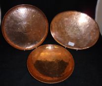 A Newlyn copper plate with beaten decoration stamped "Newlyn",