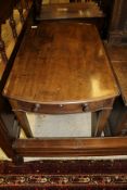 A 19th Century mahogany Pembroke table of oval form with drop leaves and single drawer above square