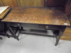A 20th Century oak side table with two drawers to the top,