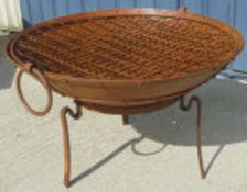 A firepit of large proportion on stand with grill* CONDITION REPORTS Is modern.
