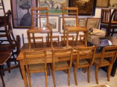 A 20th Century rectangular teak dining table on square section tapering legs,