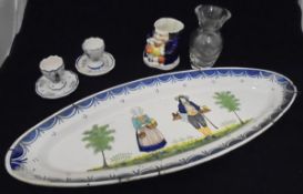 Five pieces of Quimper faience pottery wares including an oval serving dish, two egg cups,