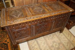 A 19th Century oak coffer, the top with three diamond carved panels,
