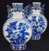 A pair of Chinese blue and white moonflask vases bearing four character marks to bases and an